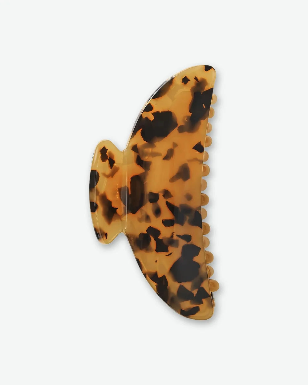 Tortoiseshell claw hair clip in warm amber and dark brown tones.