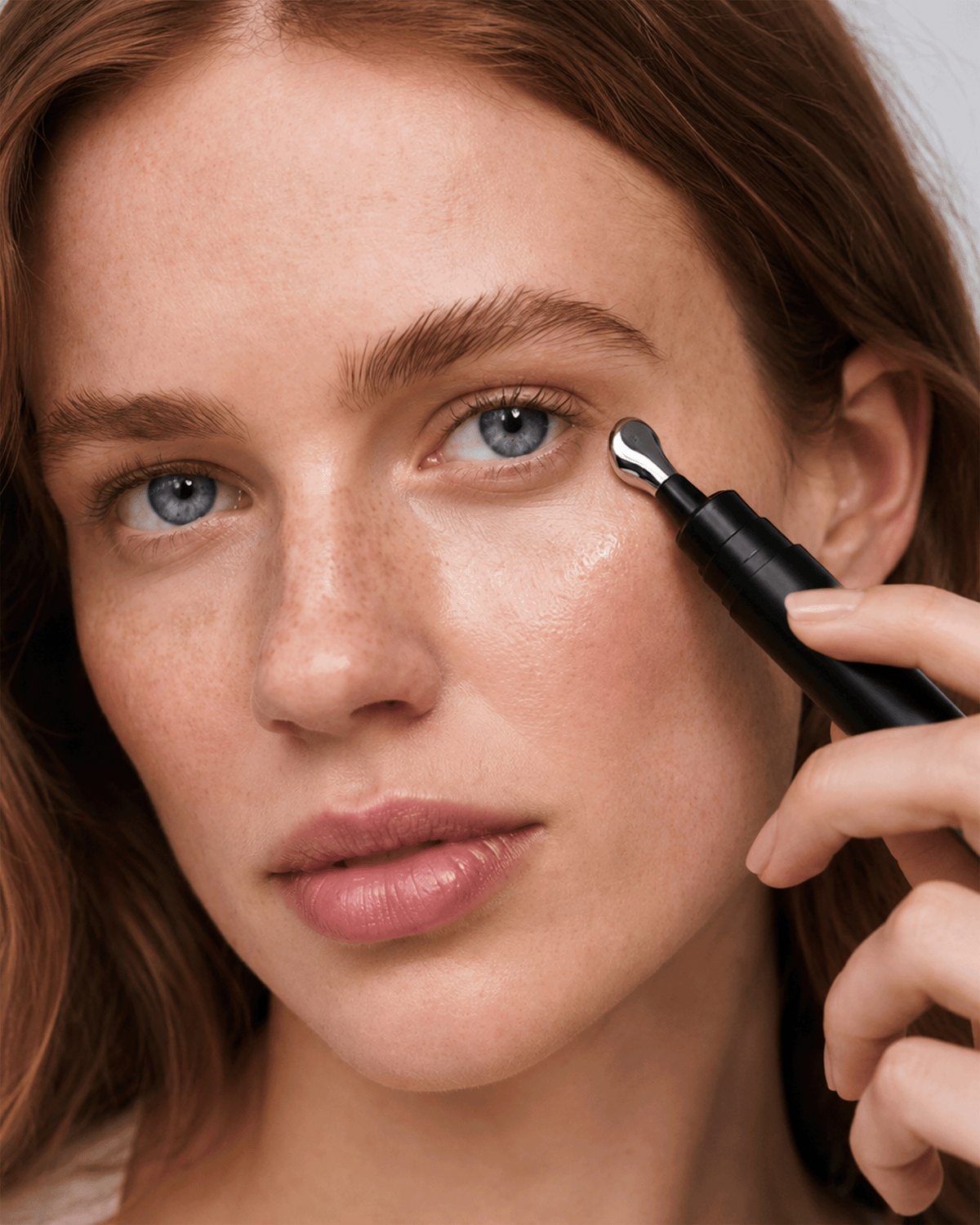 Model applying Dr. Marnie Wrinkle Pen around the eye with the metal applicator tip.