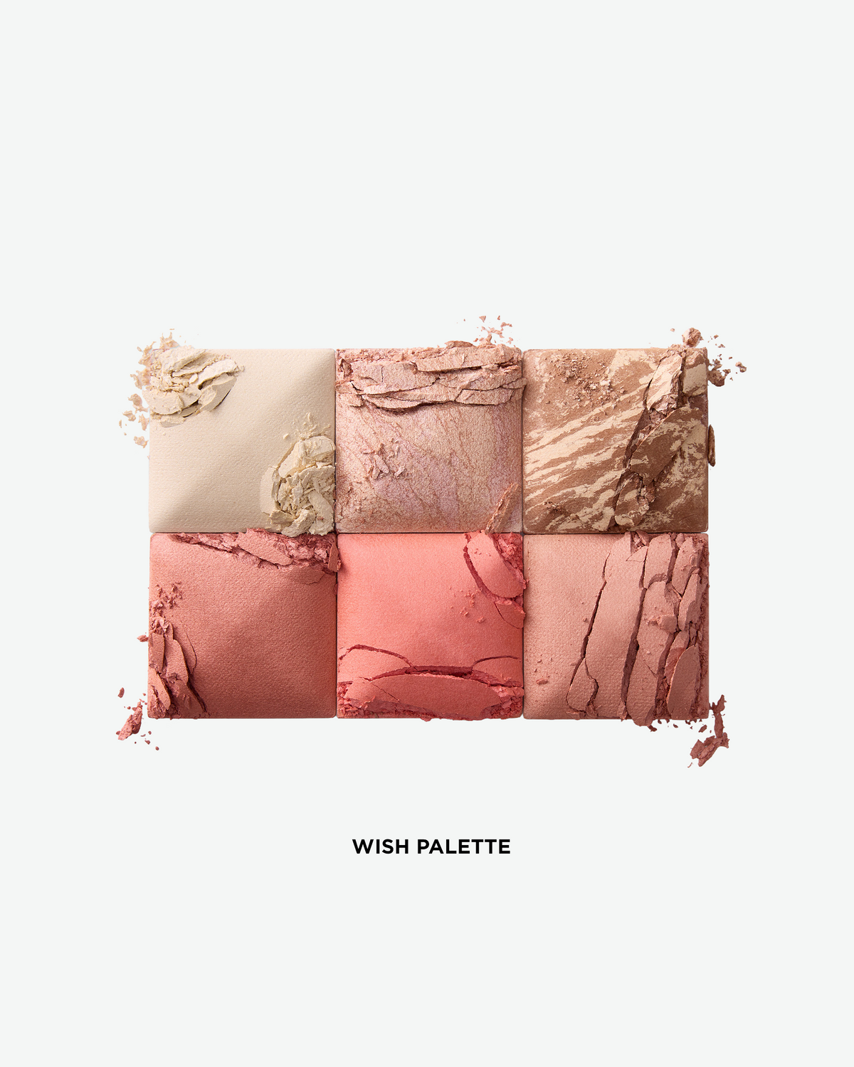 Close-up of the six shades in the Hourglass Wish Palette, showing a mix of finishing powder, highlighter, bronzer, and blush tones in soft neutral and rosy hues.