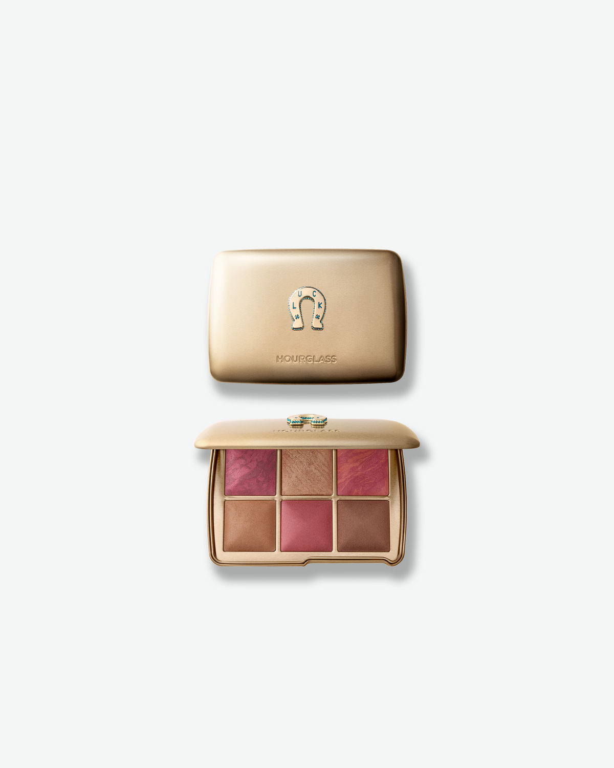 Hourglass Ambient Lighting Edit – Unlocked Palette in Luck, shown closed and open in a gold compact with six complexion shades and a decorative horseshoe emblem.