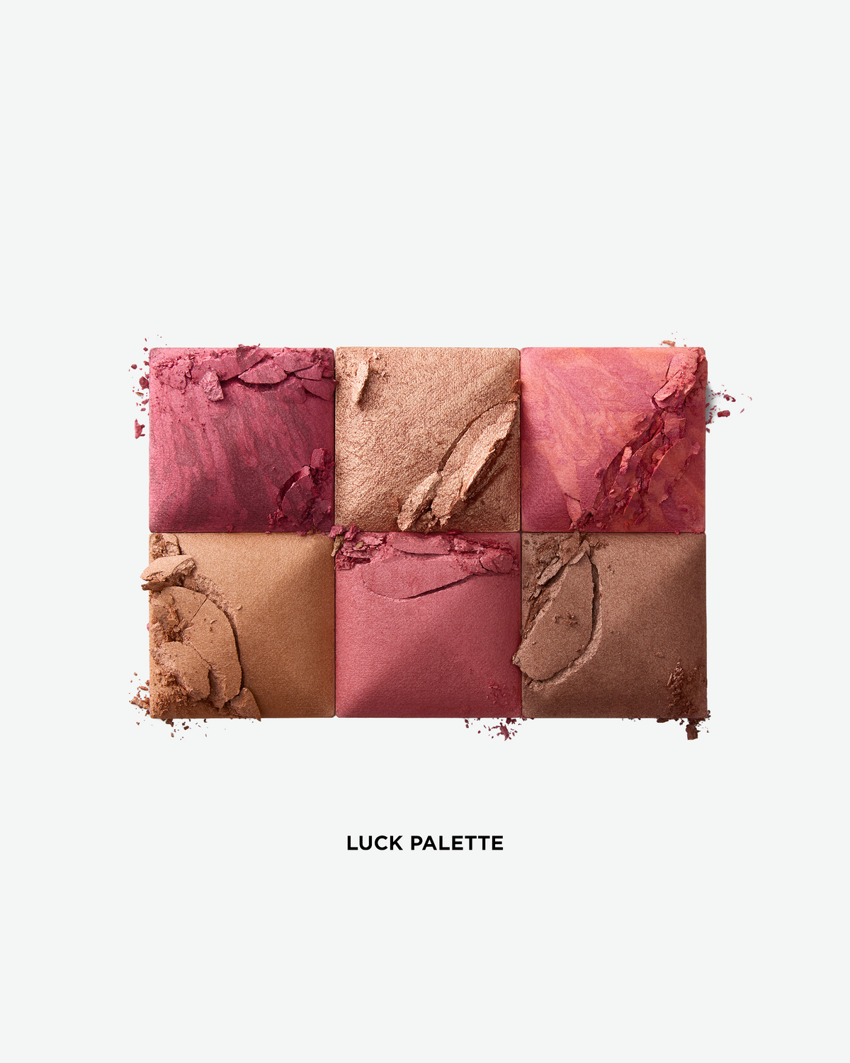Close-up of the six shades in the Hourglass Ambient Lighting Edit – Unlocked Palette in Luck, featuring rich blush, highlighter, finishing powder, and bronzer tones.