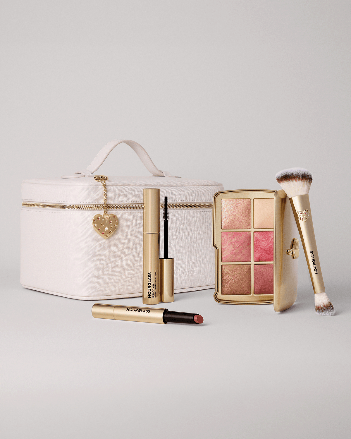 Model wearing a soft, luminous Hourglass holiday makeup look with rosy cheeks, subtle bronzed eyes, and glossy pink lips.