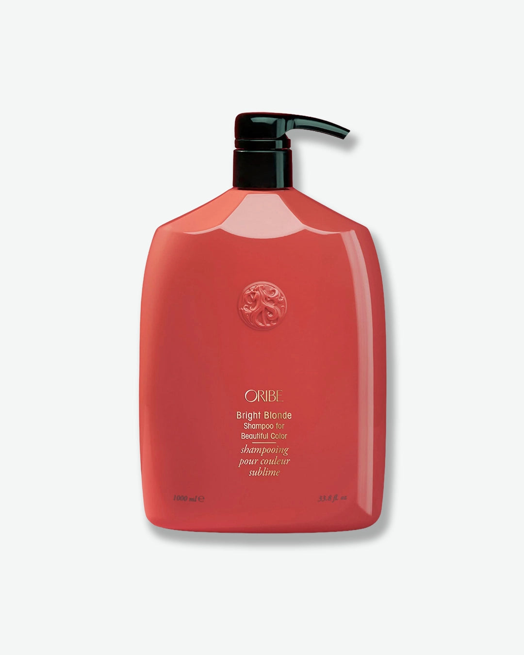 Red shampoo bottle with black pump on a white background
