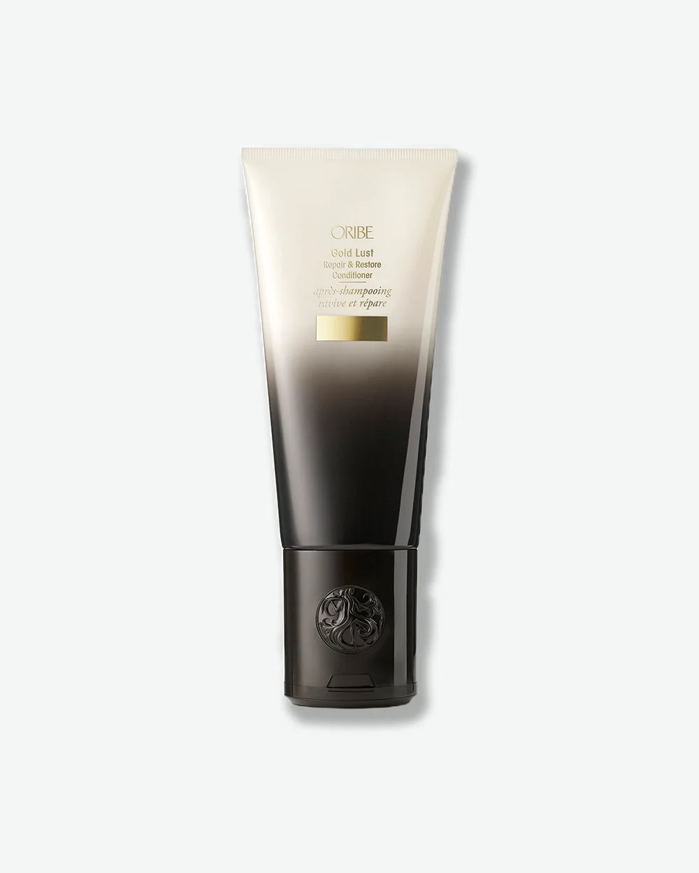 Oribe Gold Lust Repair & Restore Conditioner in a black-and-ivory gradient tube with gold detailing.