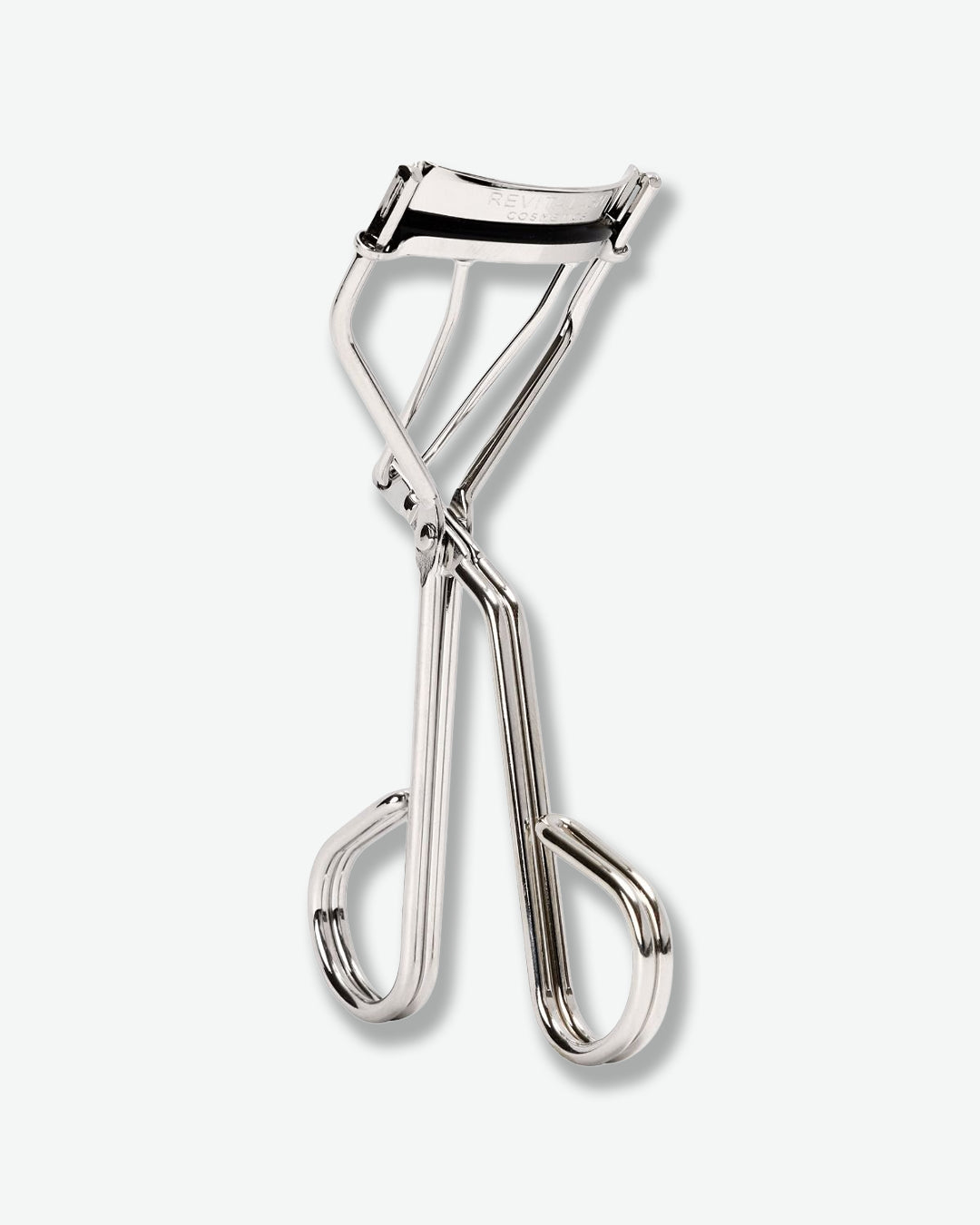 Metallic eyelash curler on a white background