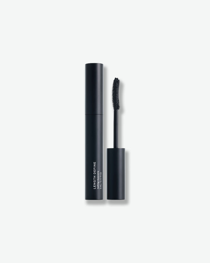 Black mascara with brush on a white background