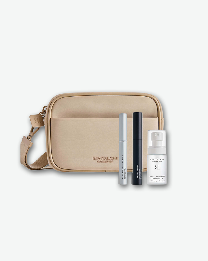Beige crossbody bag with RevitaLash products on a white background