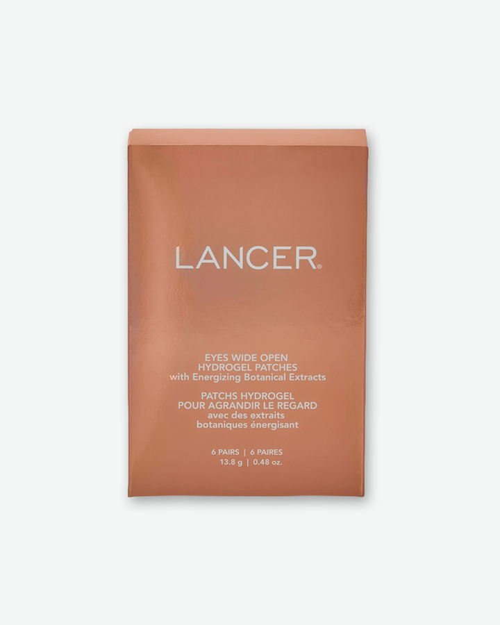 A product shot of the outer packaging box for Lancer Eyes Wide Open Hydrogel Patches, centered against a plain light gray background. The rectangular cardboard box features a metallic copper-bronze finish with smooth, reflective edges. The "LANCER" brand name is printed in large white sans-serif capital letters across the upper-middle section, followed by the product name and descriptive details below in a smaller white font.