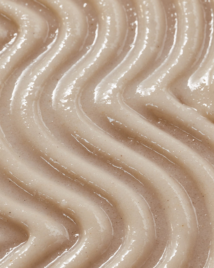 Close-up of smooth, beige-colored cream with wavy patterns