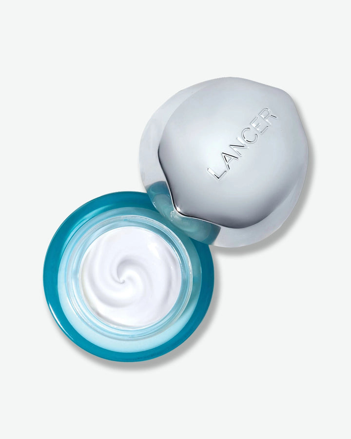 Lancer skincare product with open container showing cream inside on a light gray background