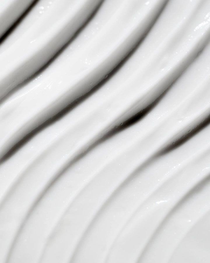 Close-up of white cream texture with wavy lines