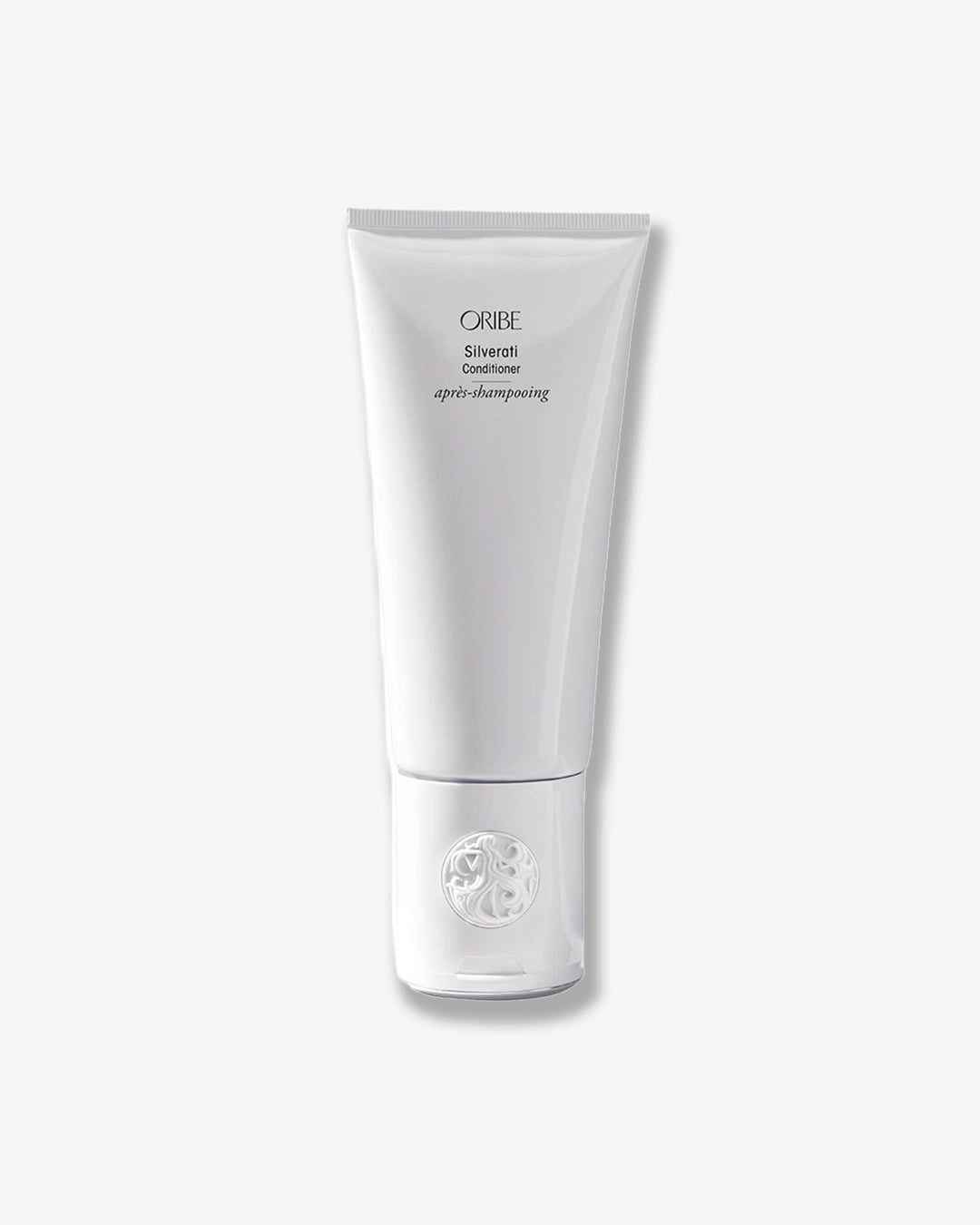 White tube of Oribe hair product on a white background