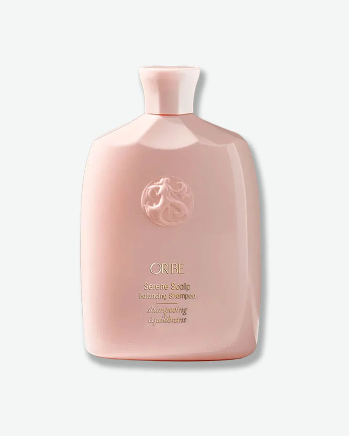 Pink shampoo bottle with Oribe logo on a white background