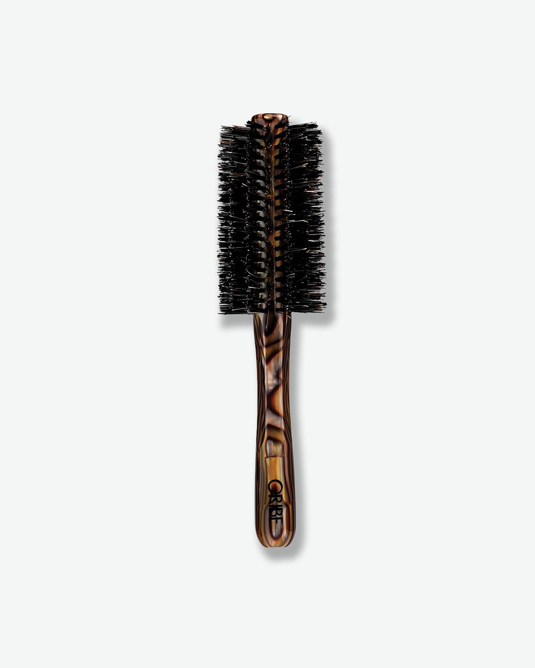 Round hairbrush with tortoiseshell handle on a white background