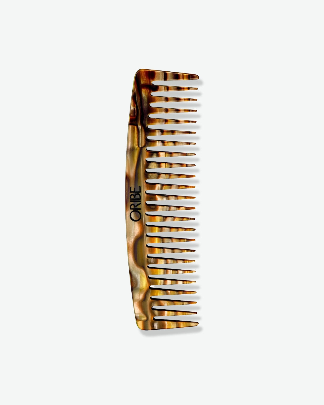 Tortoiseshell comb with 'Oribe' branding on a white background