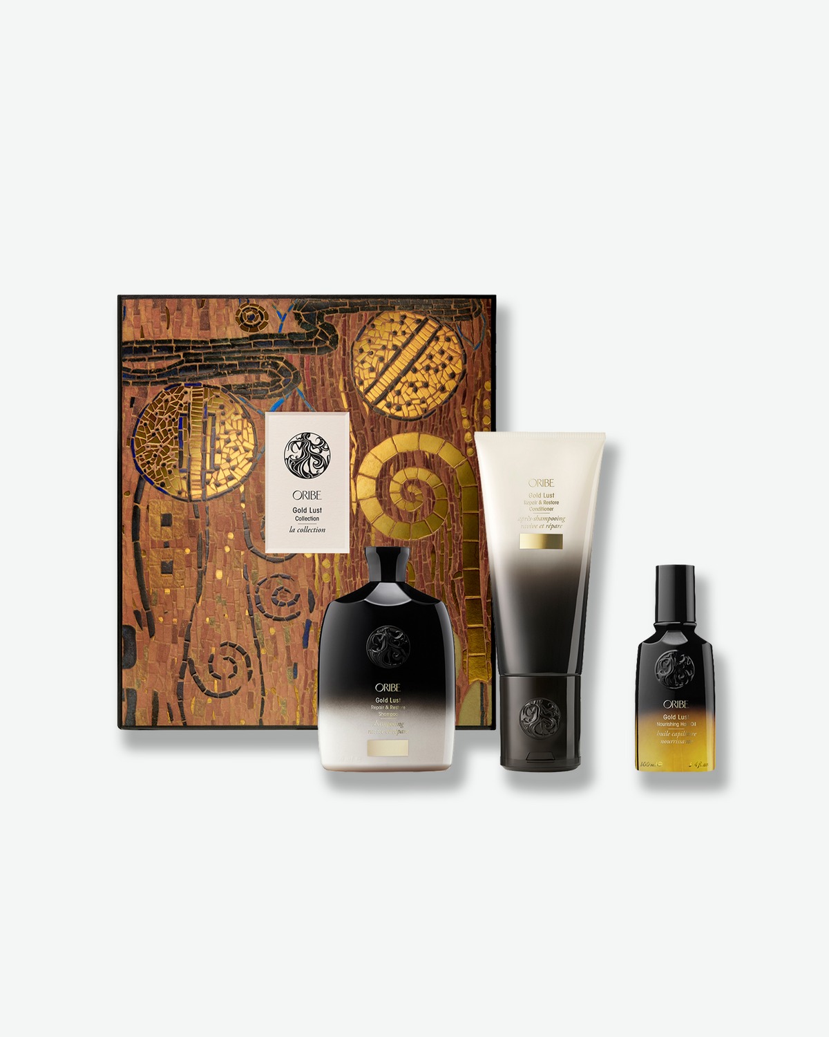 Oribe Gold Lust Collection holiday set with limited-edition mosaic gift box, Gold Lust Repair & Restore Shampoo, Conditioner, and Nourishing Hair Oil.