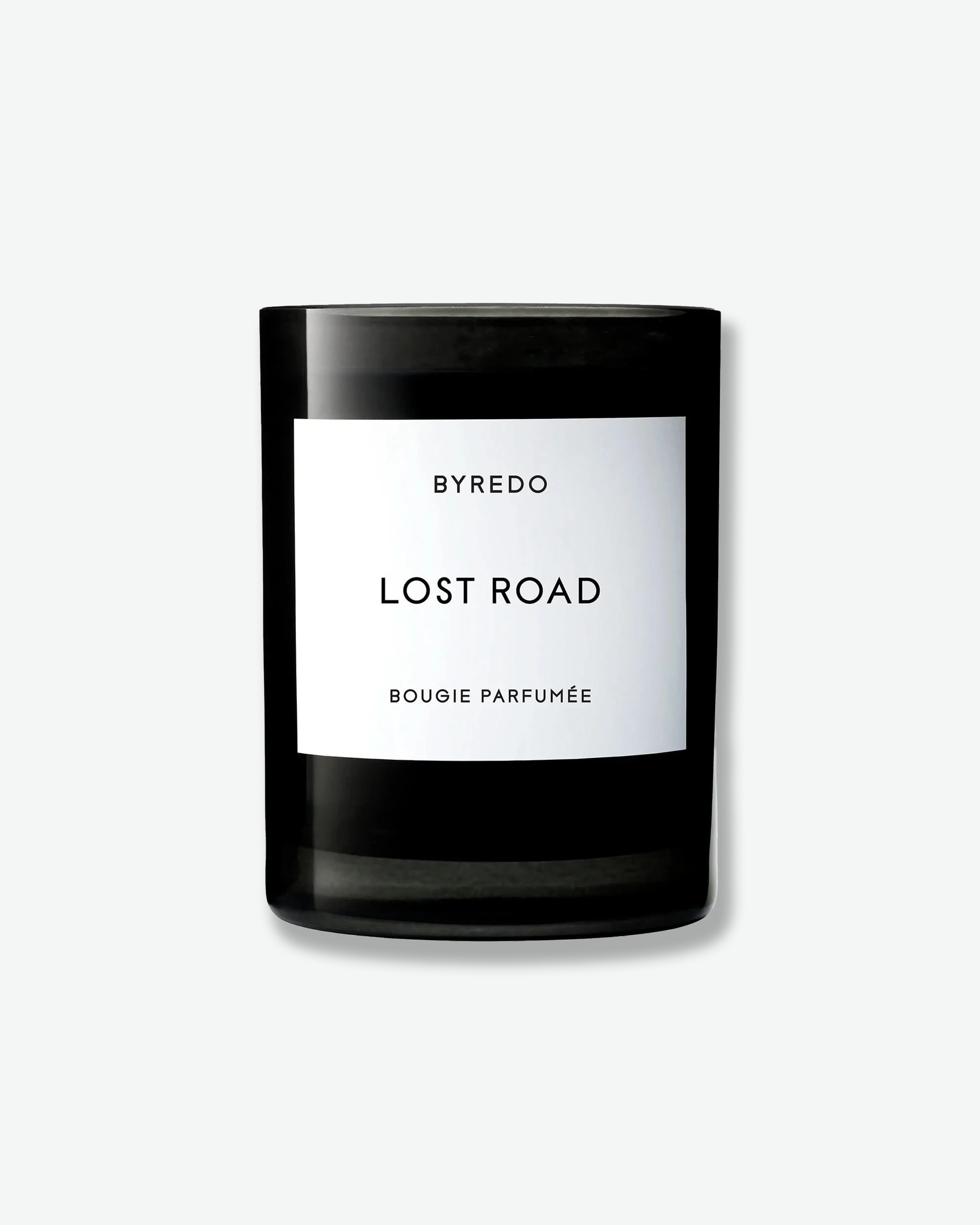 A black glass jar candle with a white rectangular label reading BYREDO SUMMER RAIN BOUGIE PARFUMÉE, centered on a light gray background.
