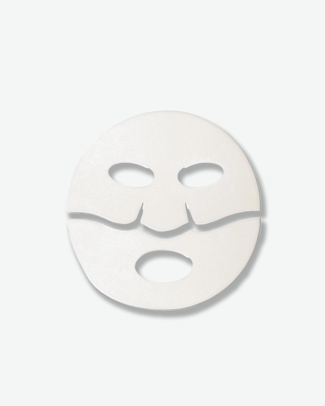 A top-down shot of a single white Dr. Barbara Sturm sheet mask, centered against a light gray background. The mask is divided horizontally into two separate pieces—a top half with eye cutouts and a bottom half with a mouth cutout—designed to seamlessly fit the contours of the face.