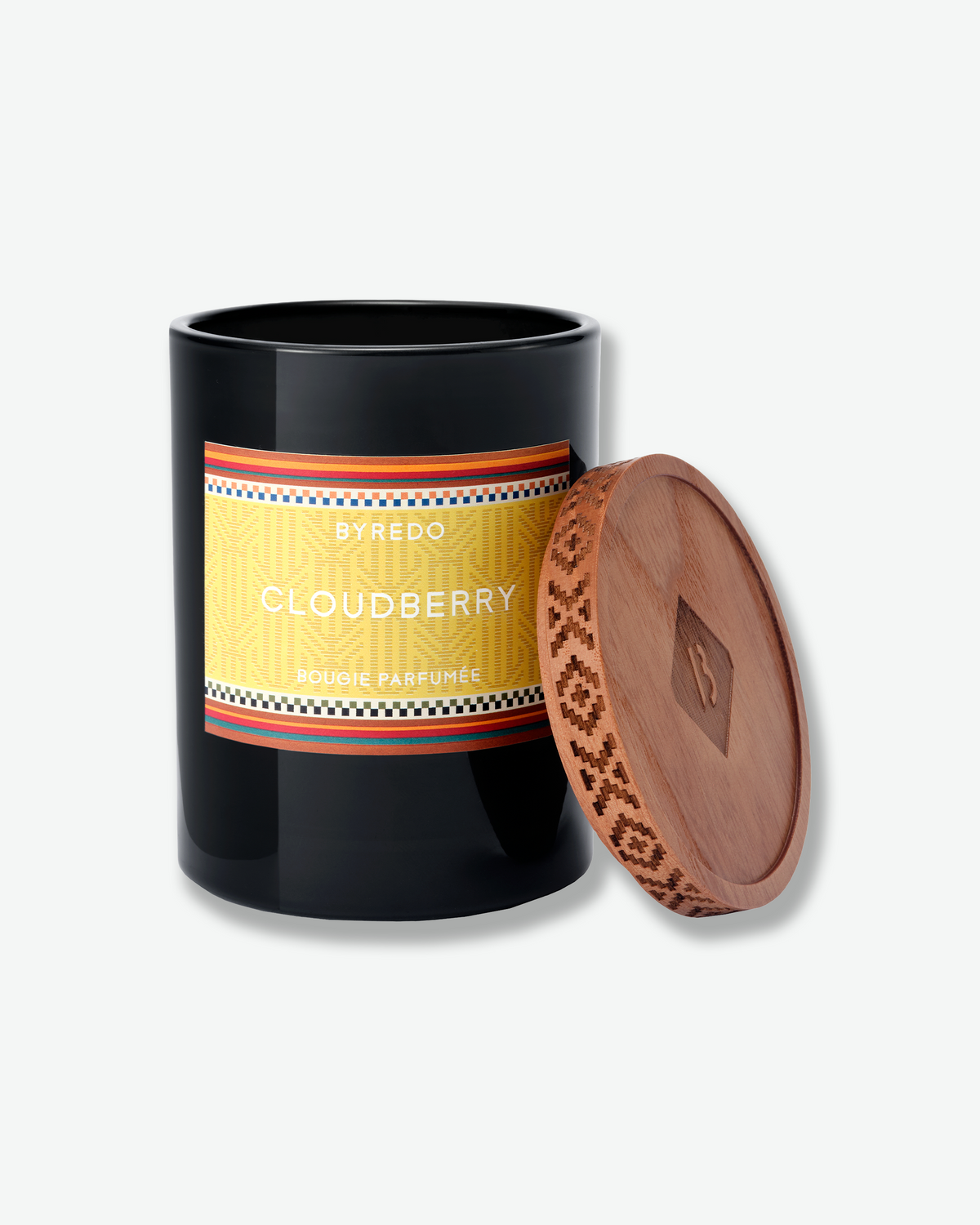 Open Byredo Cloudberry candle in a black glass vessel with the decorative wooden lid resting beside it.