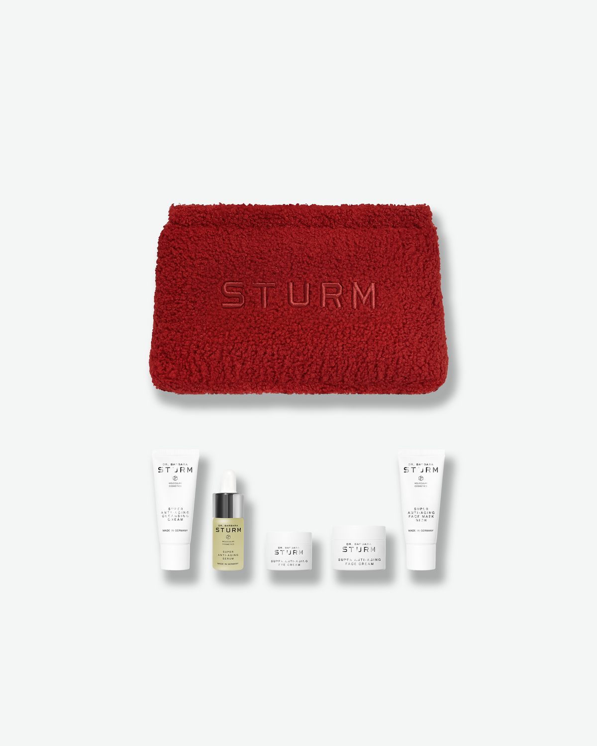 Dr. Barbara Sturm limited-edition Winter Kit featuring a red textured pouch and five Super Anti-Aging skincare minis.