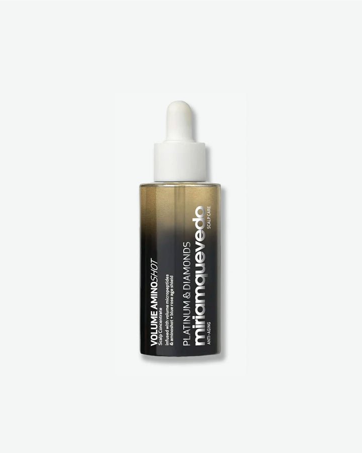 A vertical product shot of Miriam Quevedo Platinum & Diamonds Volume Aminoshot Scalp Concentrate. The bottle features a modern gradient transition from a clear, golden-hued liquid at the top to a solid black base. It is topped with a white dropper cap assembly and features vertical white typography detailing the brand and product line name.