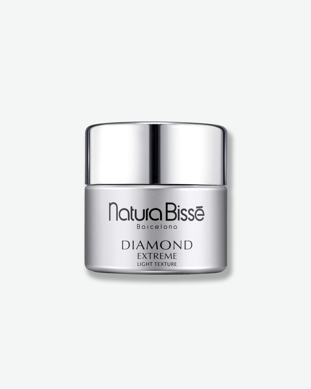 Front view of a Natura Bissé Diamond Extreme Light Texture cream jar centered against a plain gray background. The sleek cylindrical container features a matte metallic silver-grey body with minimalist black text branding, topped with a polished, high-shine silver cap.