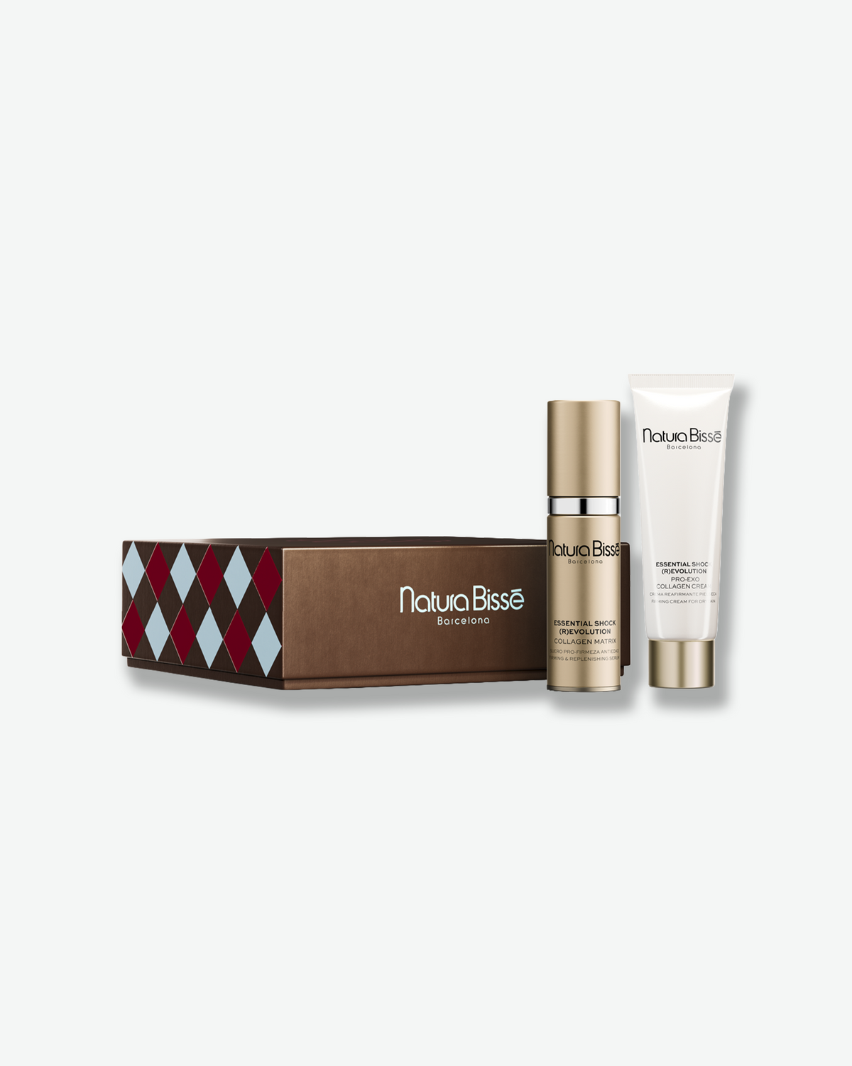 Natura Bissé Essential Shock (R)Evolution skincare gift set featuring Collagen Matrix serum and Pro-Renewal Collagene Cream, displayed alongside a brown holiday gift box with a festive diamond pattern.