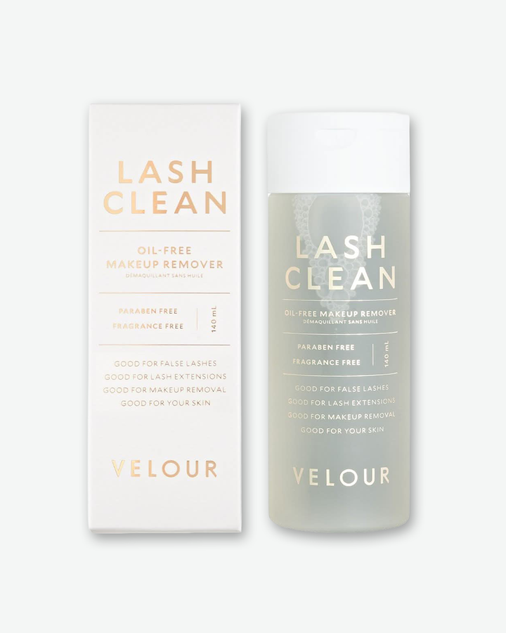 Front view of a bottle of Velour Lash Clean Oil-Free Makeup Remover against a plain gray background. The cylindrical bottle is made of frosted, translucent plastic that reveals a clear liquid solution with slight bubbling near the top, finished with a solid white flip-top cap and rose-gold lettering.