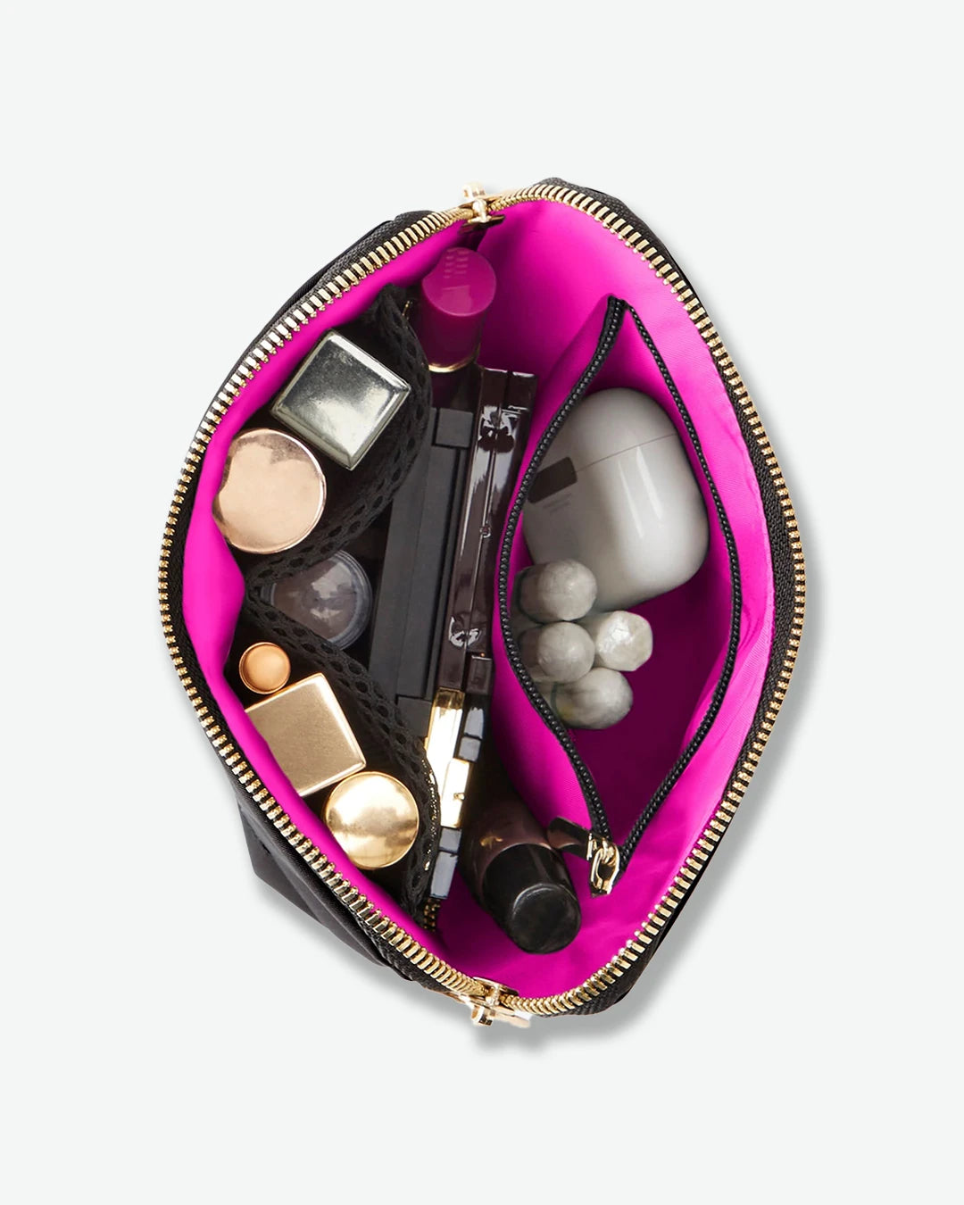 Pink makeup pouch with various cosmetic items on a white background