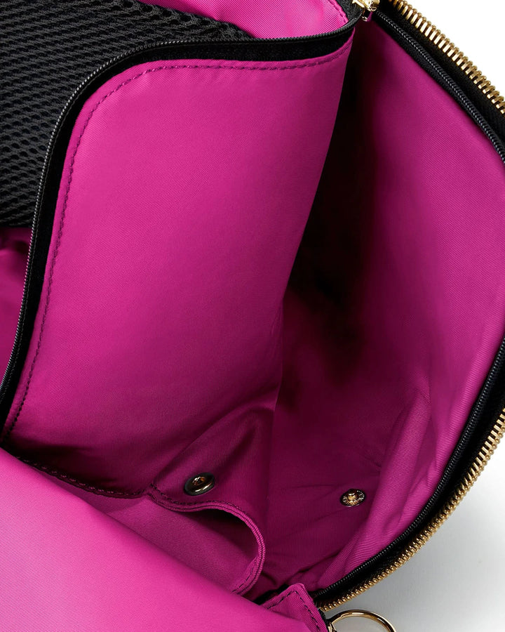 Close-up of a pink bag with gold zipper on a white background