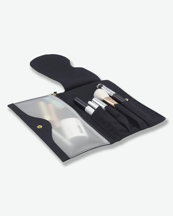 Set of makeup brushes in a black case on a white background