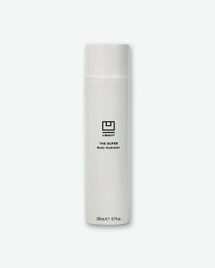 A product shot of a U Beauty The Super Body Hydrator bottle, centered against a plain light gray background. The tall, cylindrical bottle is a glossy white color with a matching flush cap. The front features the minimalist black square U Beauty logo emblem, the product name "THE SUPER Body Hydrator", and the volume markings "200 mL e 6.7 fl. oz." at the bottom.