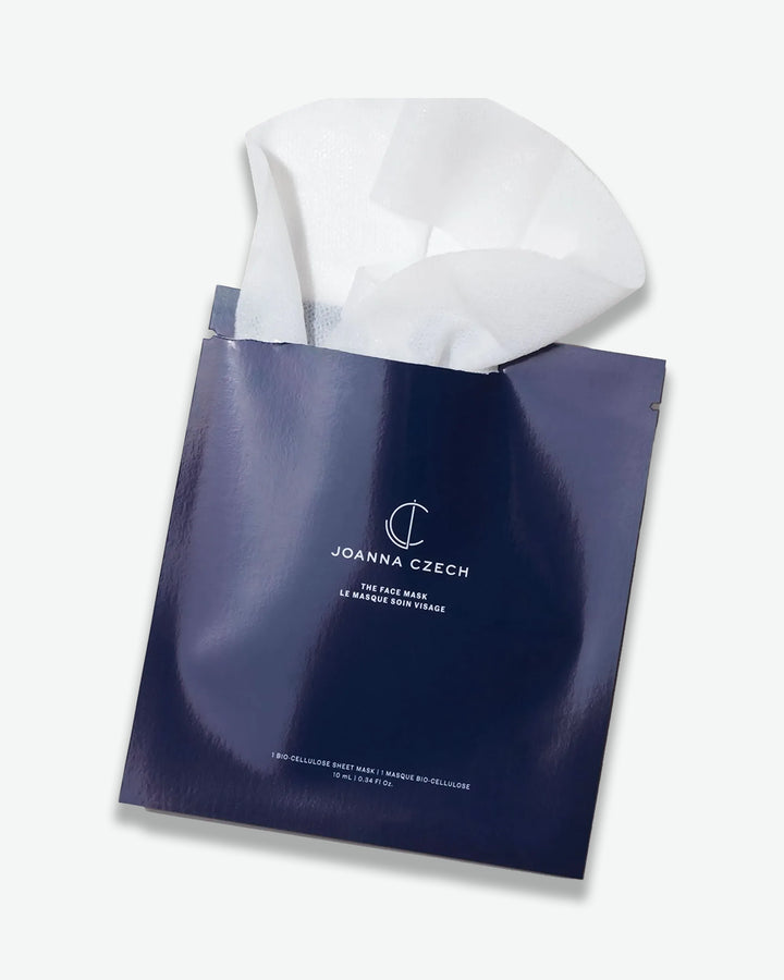 Blue bag with white face mask inside, branded 'Joanna Czech'.