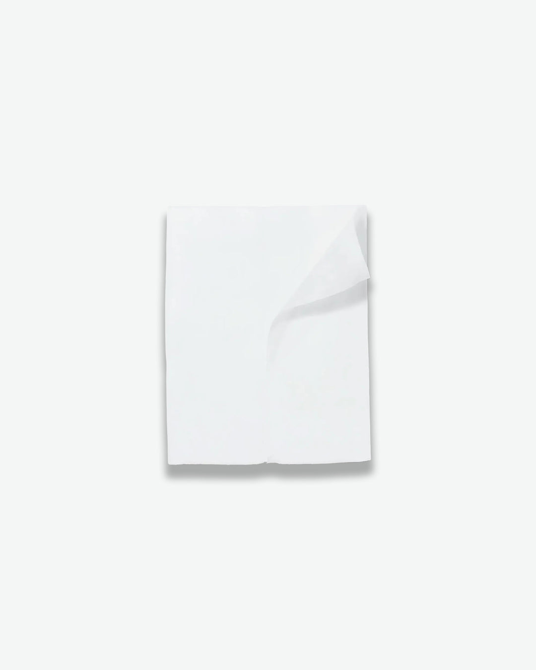 White folded towel on a light gray background