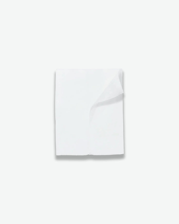 White folded towel on a light gray background