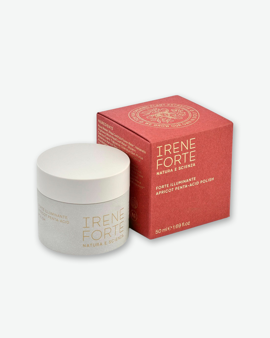 Irene Forte Forte Illuminante Apricot Penta-Acid Polish in a textured, light grey stone-like jar with a smooth white cap, shown next to its textured terracotta-red box with gold text, isolated on a light grey background.