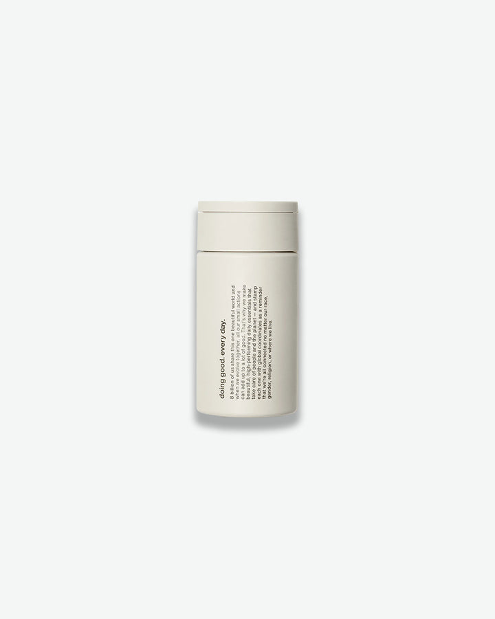 White cylindrical container with text on a white background