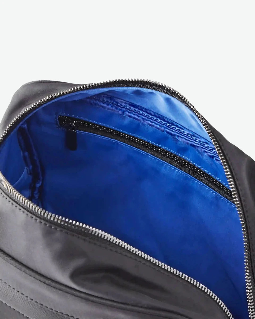 Close-up of a black bag with a blue interior on a white background