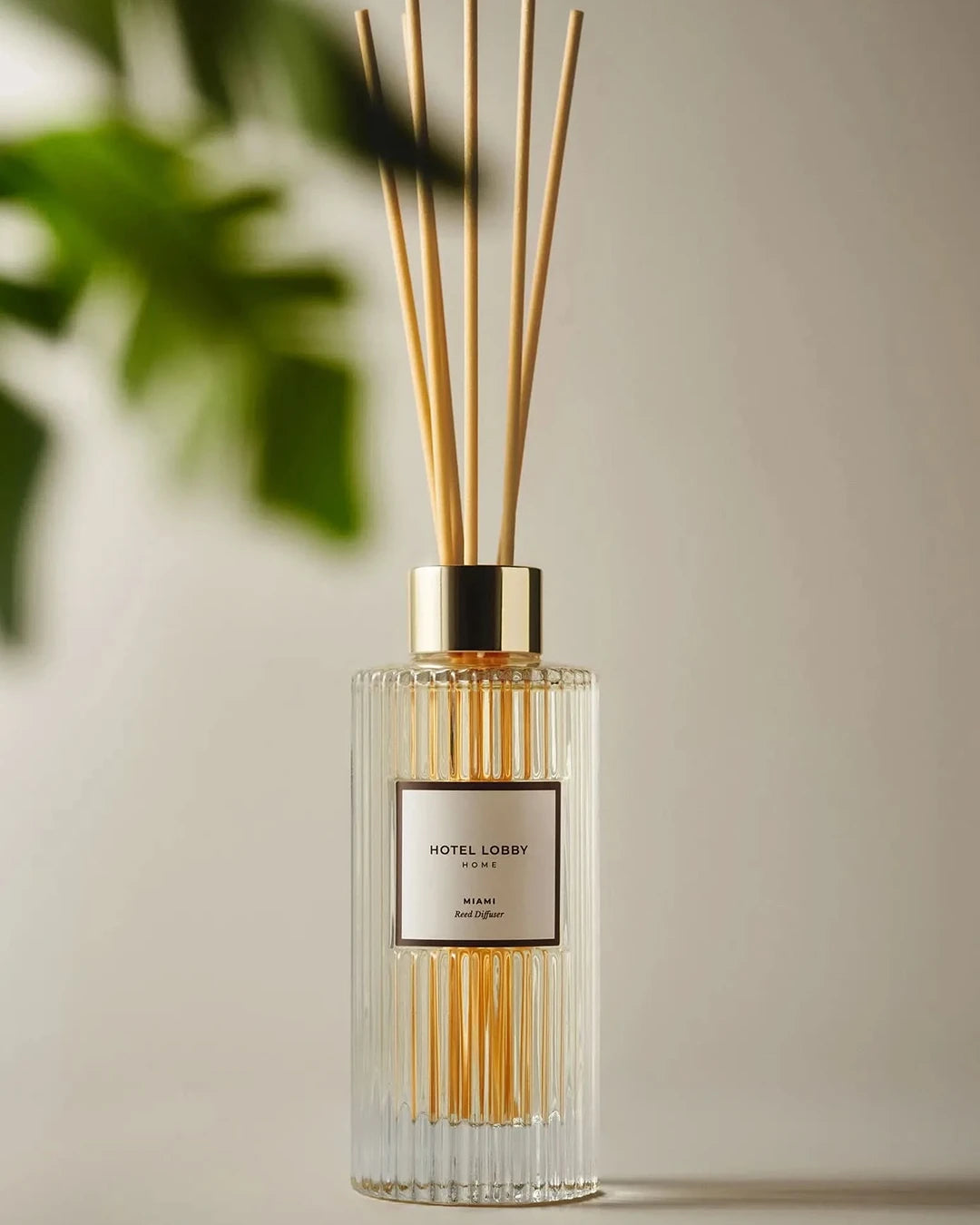 Diffuser with wooden sticks and 'Hotel Lobby' label on a neutral background