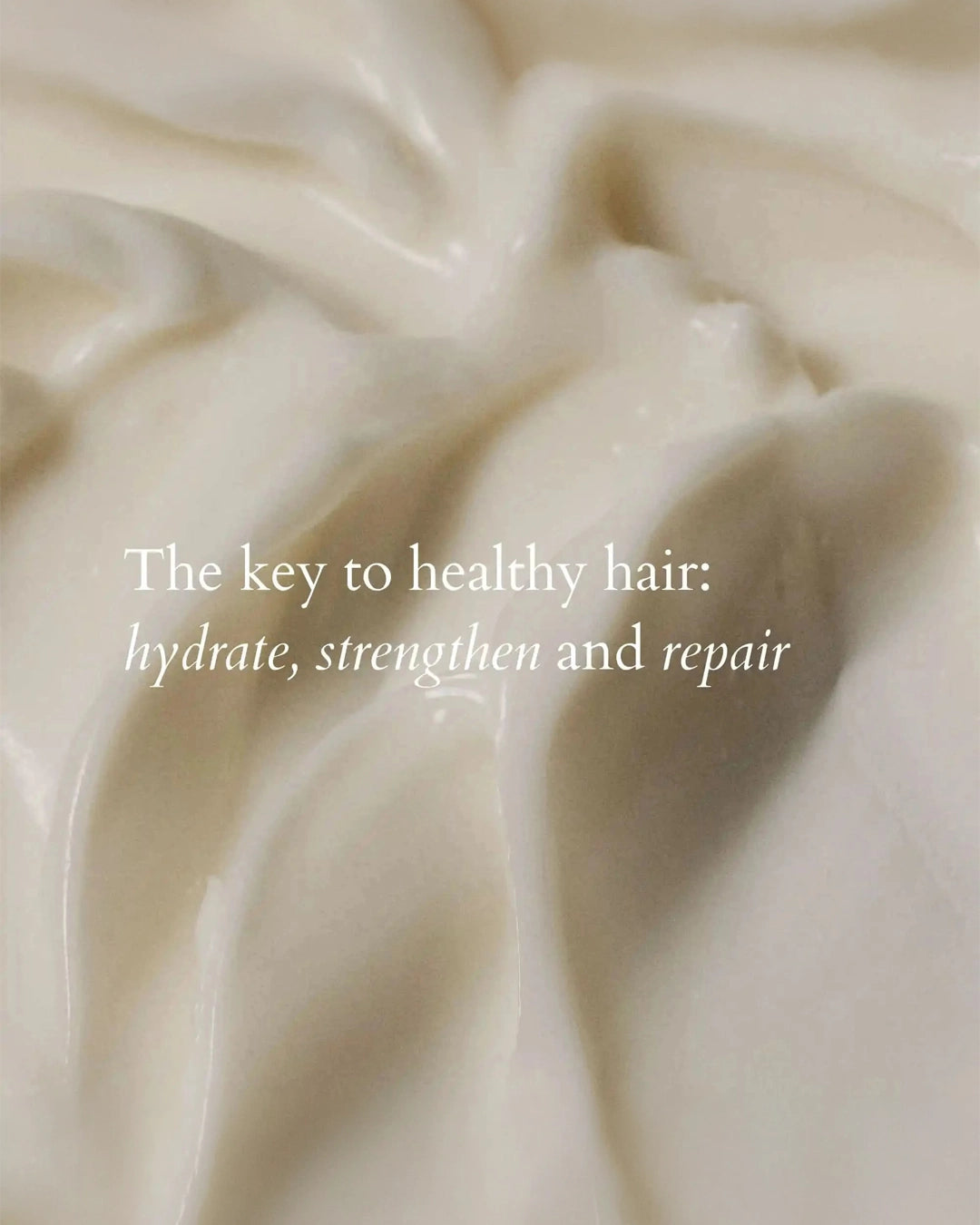 Close-up of creamy hair product with text overlay on a beige background