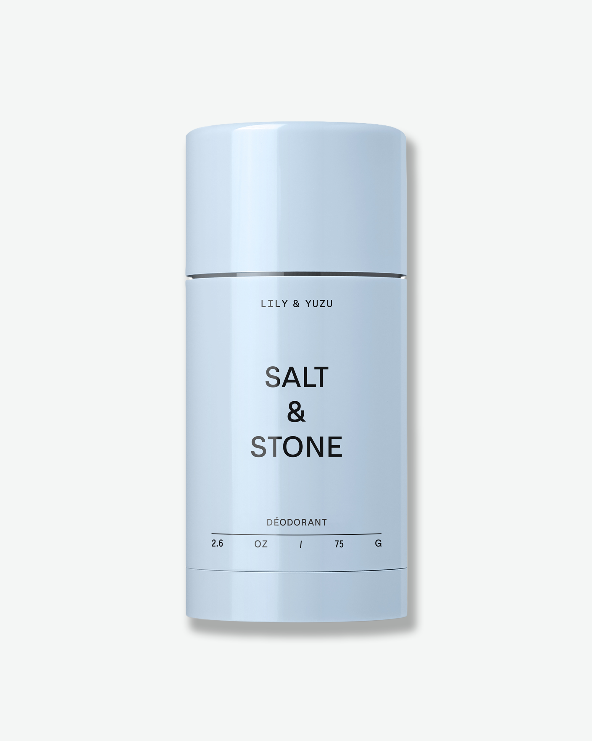 A light blue stick of Salt & Stone "Lily & Yuzu" deodorant against a white background.