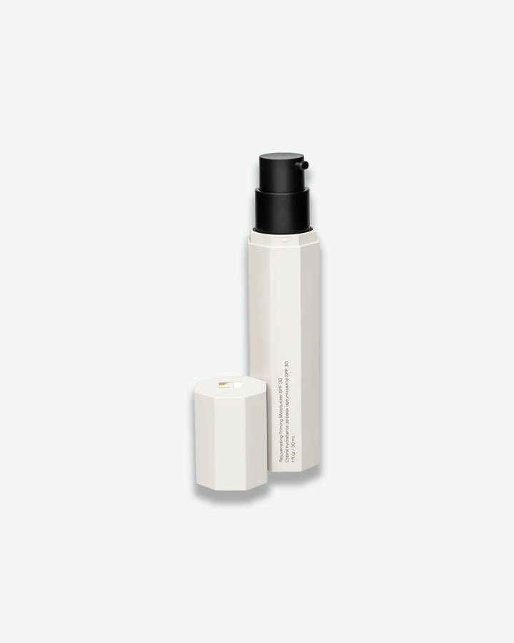 Two white cylindrical containers with black caps on a light gray background