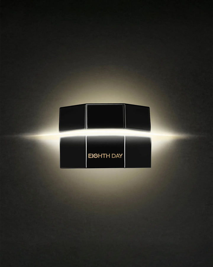 Black cosmetic product packaging with 'Eighth Day' branding on a dark background