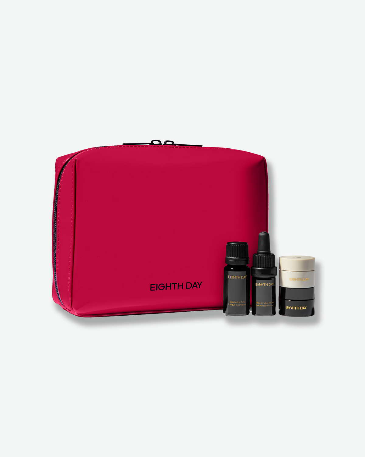 Eighth Day Regenerative Mini Collection featuring travel-size skincare essentials housed in a bold red Eighth Day cosmetic bag.
