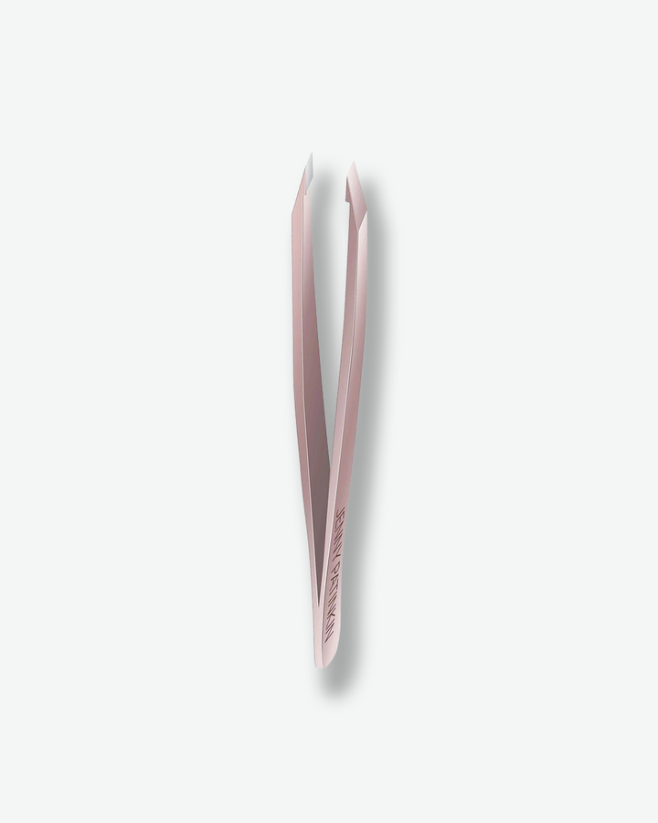 Pink tweezers on a white background