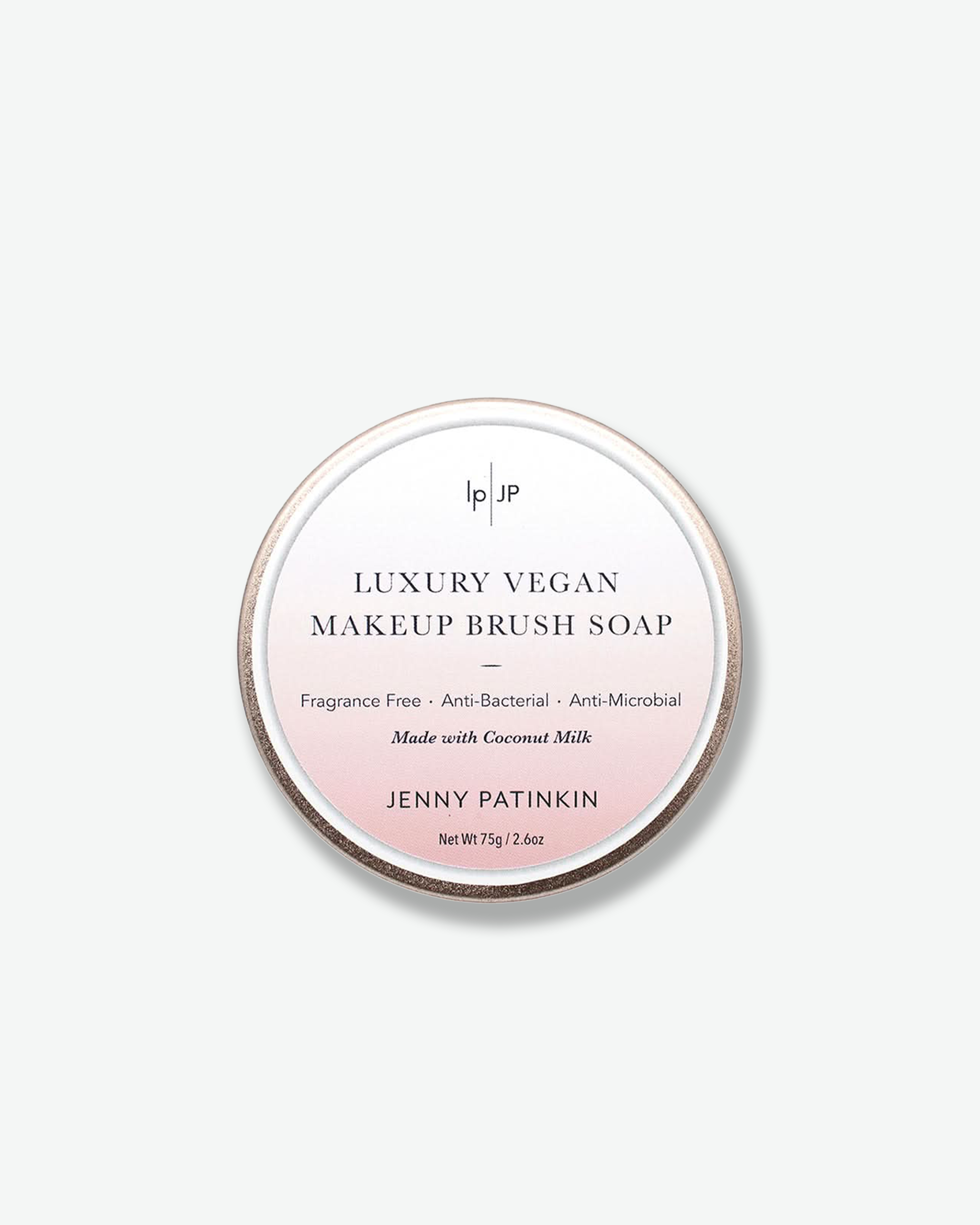 Luxury vegan makeup brush soap packaging with brand name on a light gray background