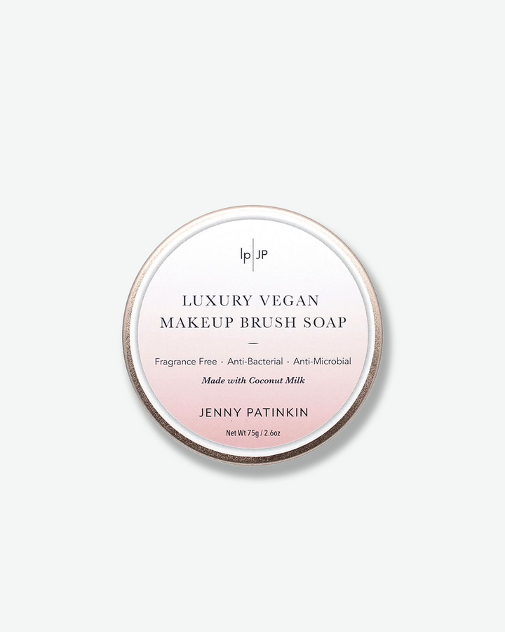 Luxury vegan makeup brush soap packaging with brand name on a light gray background