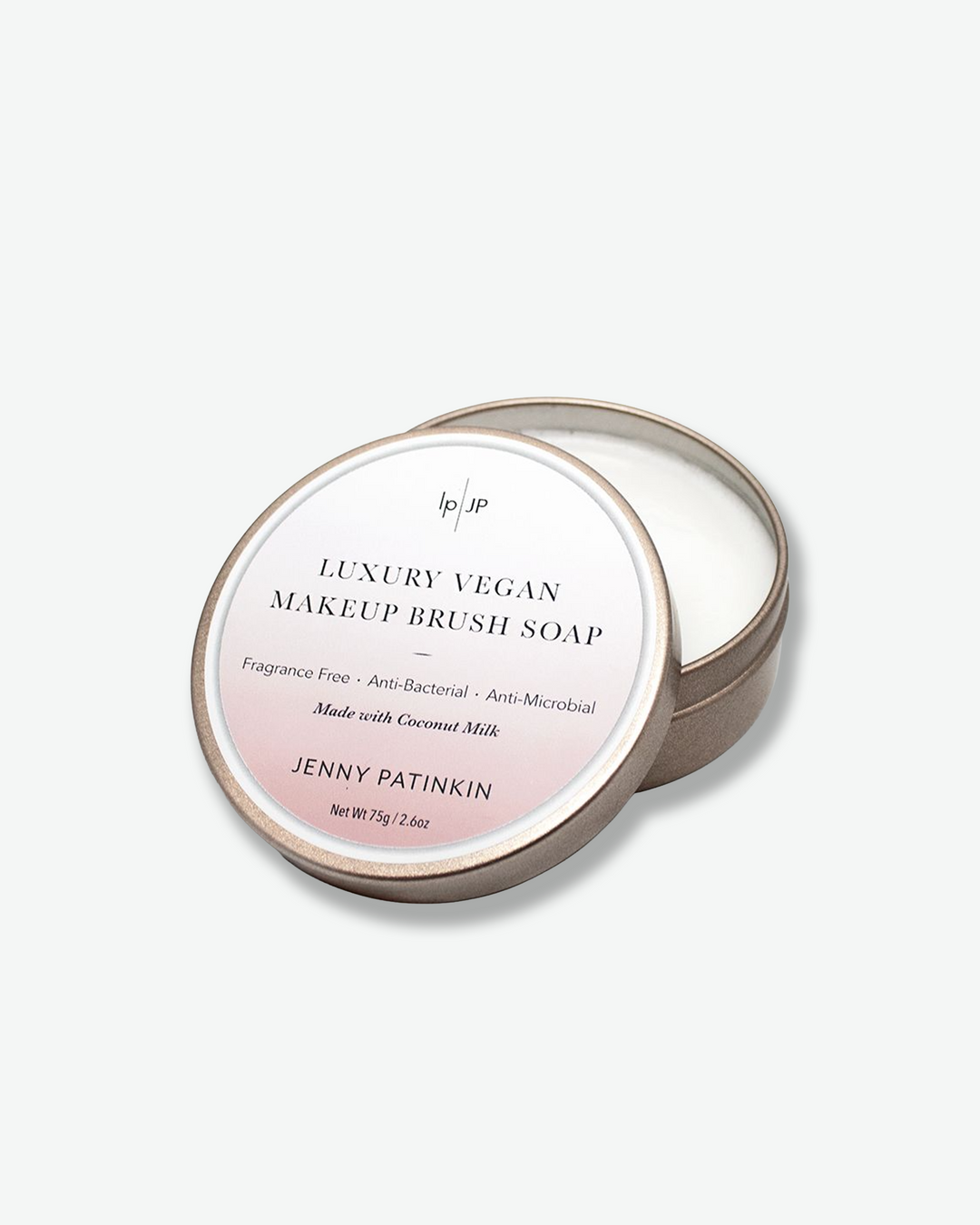 Luxury vegan makeup brush soap packaging with brand name on a light gray background