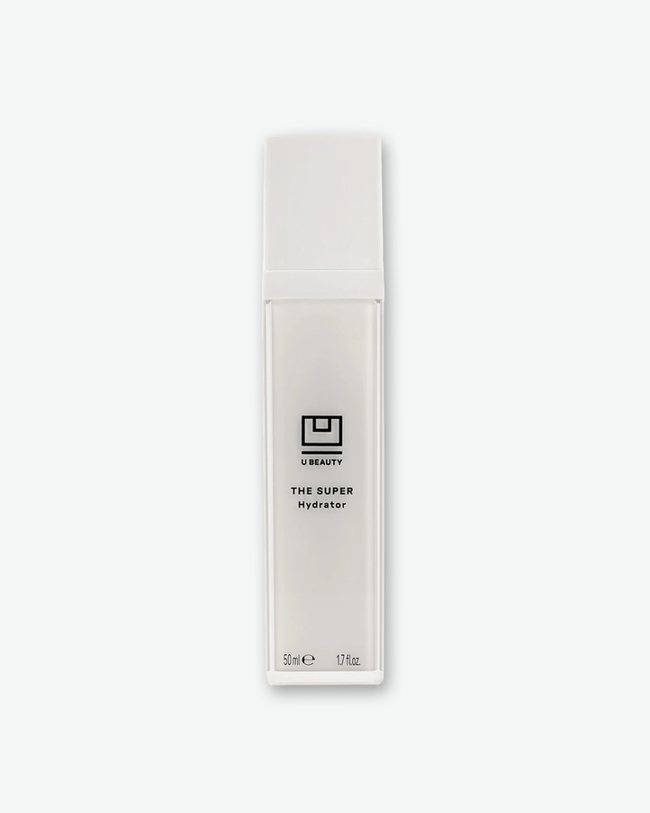 Front view of a U Beauty "The Super Hydrator" bottle against a plain gray background. The sleek, tall skincare product features a square, frosted white translucent bottle showing the inner mechanism, a solid white cap, and minimalist black branding text.