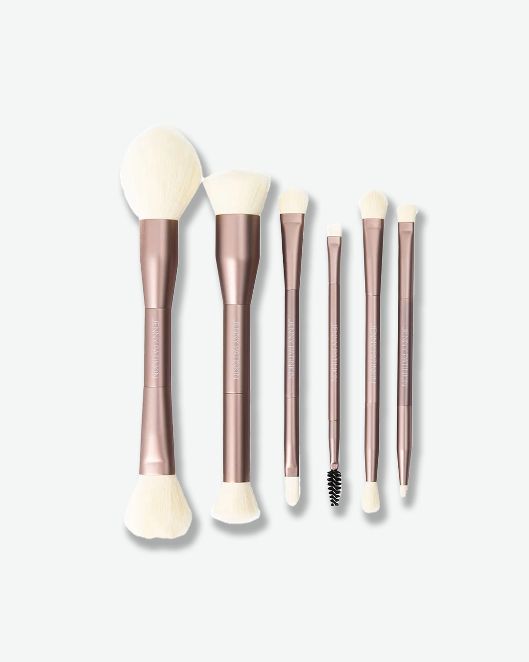 A product shot displaying six double-ended makeup brushes arranged vertically against a plain light gray background. The brushes feature shiny rose-gold handles with subtle text designating their functions—such as powder, cream complexion, and eye lining—and are tipped with soft white bristles on both ends, with one end of a slender brush featuring a black spoolie.